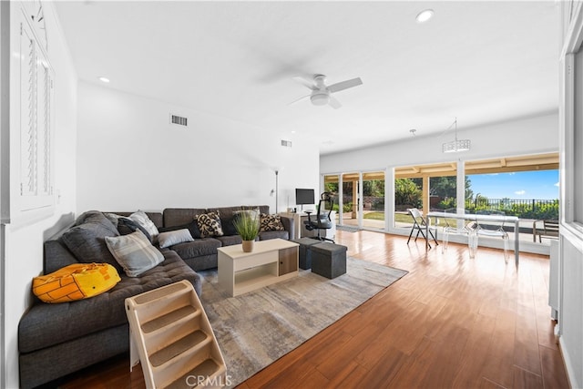 living room with hardwood / wood-style floors, french doors, and ceiling fan