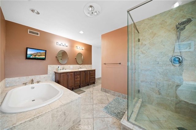 bathroom with vanity and independent shower and bath