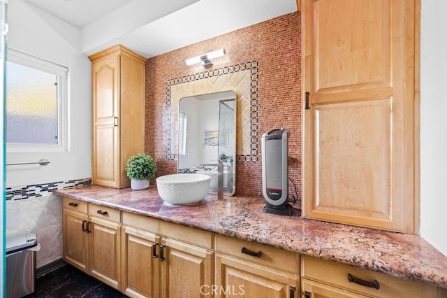 bathroom featuring vanity and tile walls