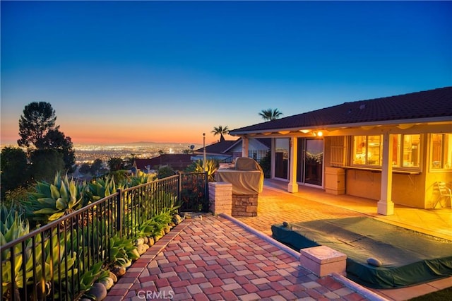 view of patio terrace at dusk