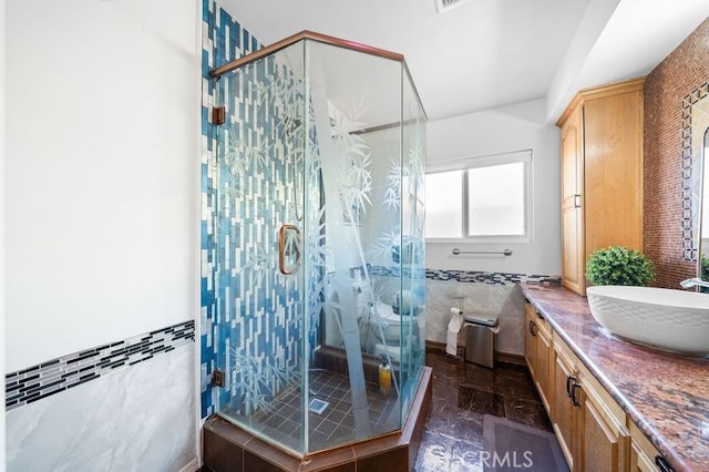 bathroom with vanity, tile walls, and walk in shower