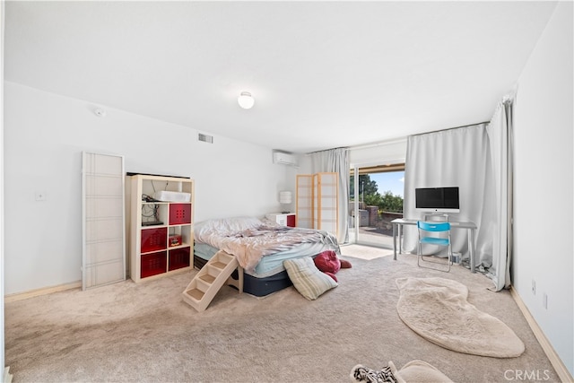 carpeted bedroom with access to outside and an AC wall unit