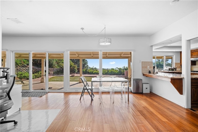 dining space with light hardwood / wood-style flooring