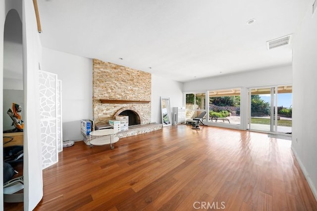 unfurnished living room featuring wood-type flooring and a fireplace