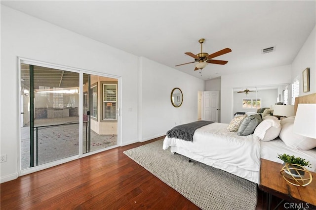 bedroom featuring baseboards, wood-type flooring, visible vents, and a ceiling fan