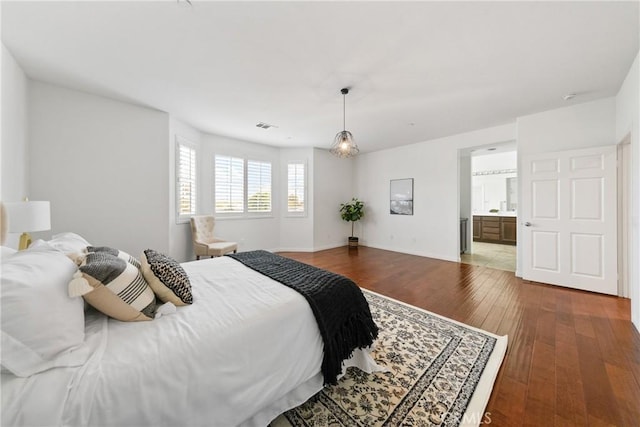 bedroom featuring baseboards, visible vents, and hardwood / wood-style floors