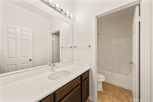 full bathroom with shower / bathing tub combination, tile patterned floors, vanity, and toilet