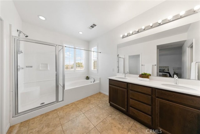 full bath with a stall shower, tile patterned flooring, visible vents, and a sink