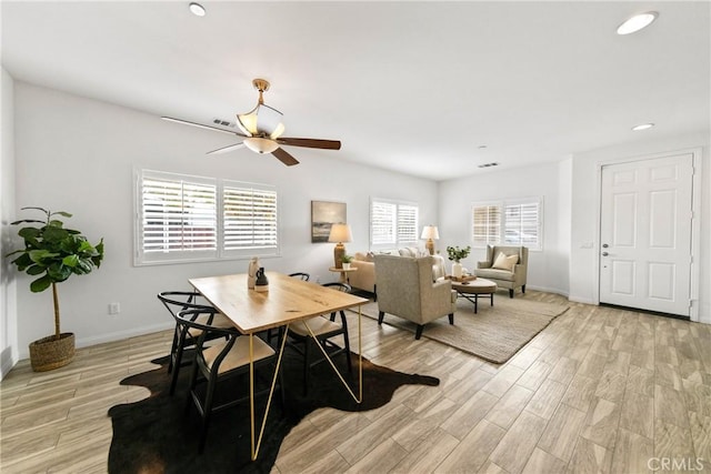 dining area featuring light wood-style floors, ceiling fan, baseboards, and recessed lighting