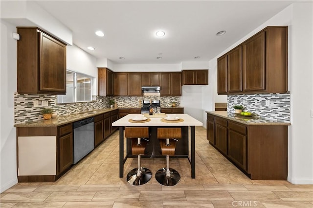 kitchen featuring recessed lighting, backsplash, appliances with stainless steel finishes, dark brown cabinetry, and under cabinet range hood