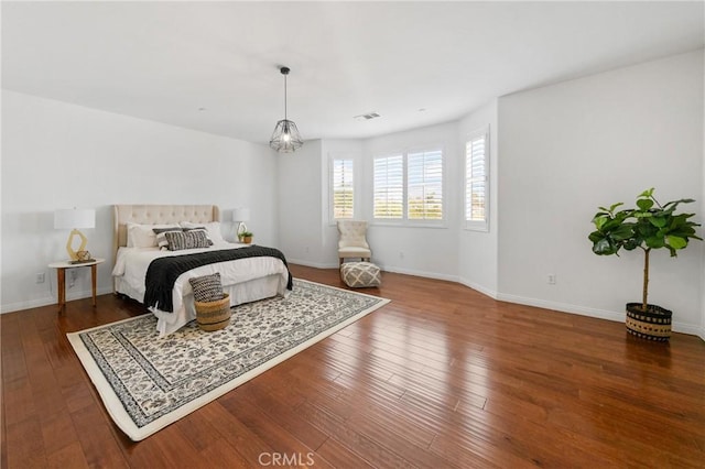 bedroom with dark hardwood / wood-style floors