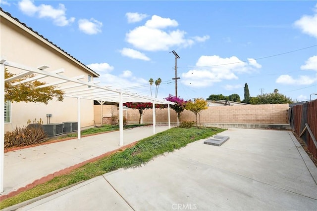 view of patio featuring a pergola, a fenced backyard, and central air condition unit