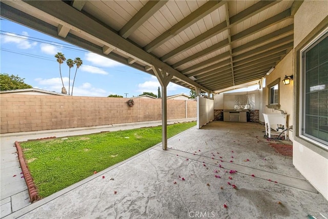 view of patio / terrace with fence and a sink