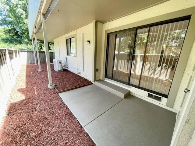 view of exterior entry featuring a patio area