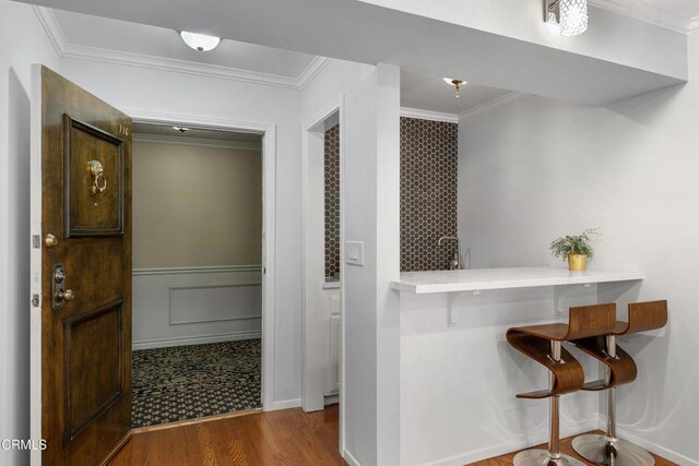 interior space with wood-type flooring and ornamental molding