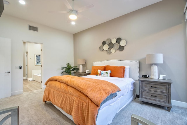 carpeted bedroom with ceiling fan and ensuite bathroom