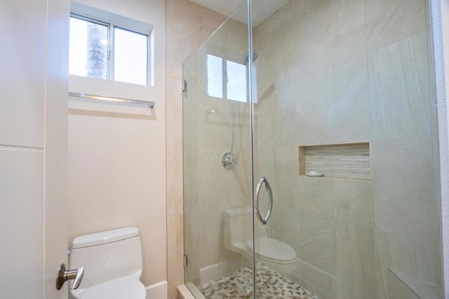 bathroom with toilet and walk in shower