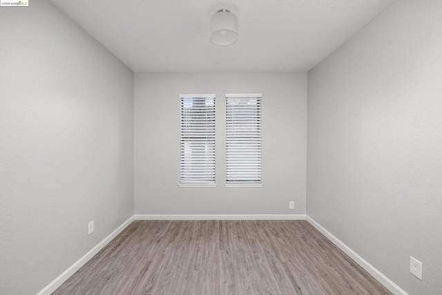 unfurnished room with light hardwood / wood-style flooring