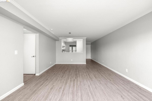 unfurnished living room with ornamental molding and light hardwood / wood-style flooring