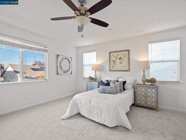 bedroom with light carpet and ceiling fan