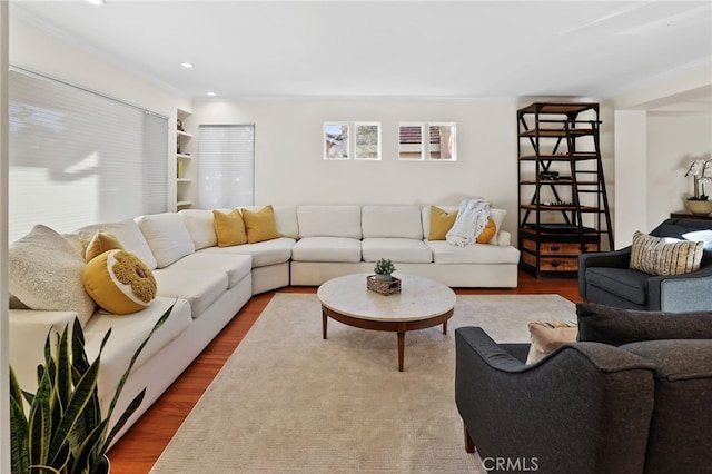 living room featuring hardwood / wood-style floors and built in features