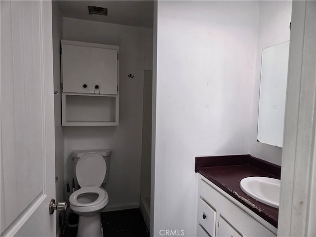 bathroom featuring vanity and toilet