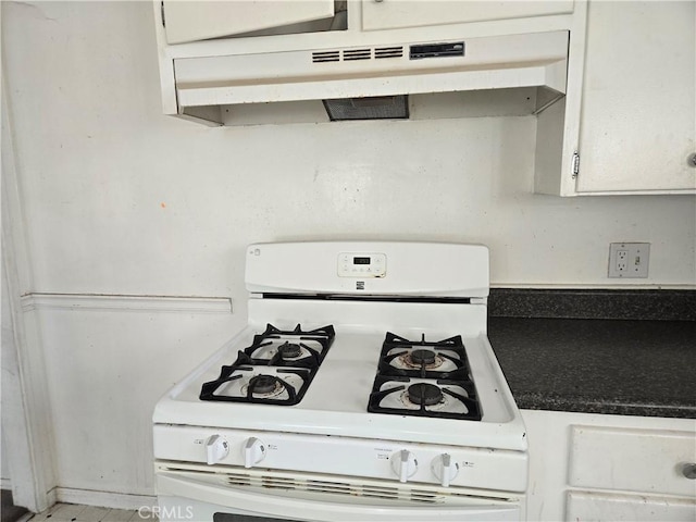 kitchen featuring white cabinetry and white range with gas cooktop