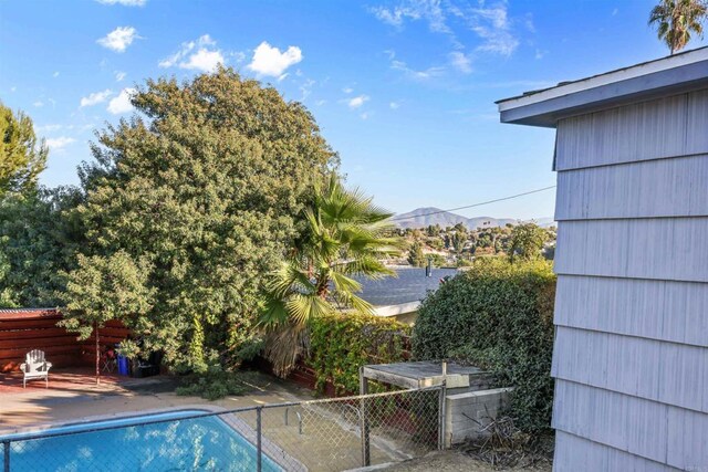 view of pool with a mountain view and a patio area