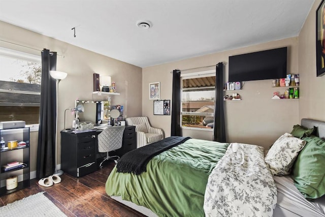 bedroom with dark hardwood / wood-style flooring and multiple windows