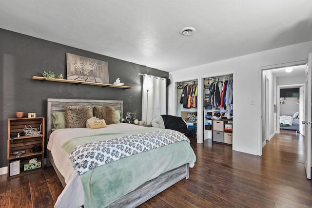 bedroom with dark hardwood / wood-style flooring