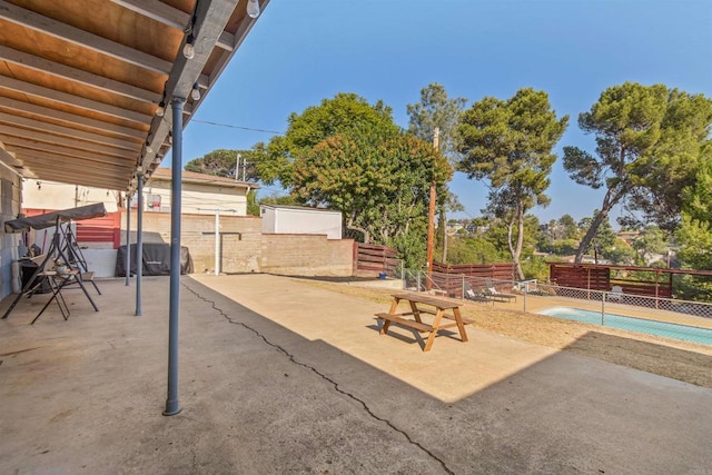 view of patio with a fenced in pool