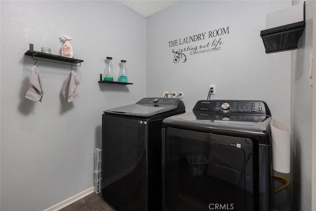 laundry room featuring washer and dryer and dark hardwood / wood-style floors