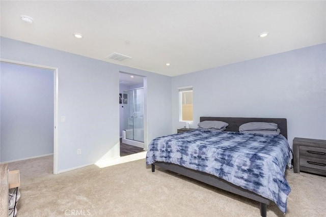 carpeted bedroom with connected bathroom