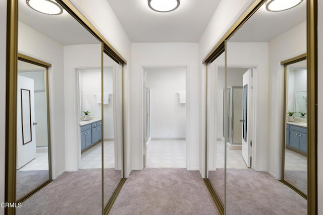 hallway featuring light colored carpet