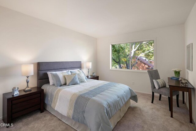 bedroom featuring light carpet