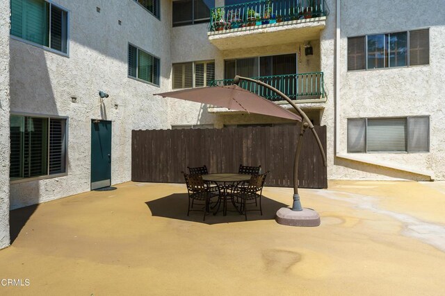 view of patio featuring a balcony