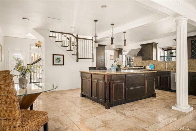 kitchen featuring ornate columns, a center island, stainless steel dishwasher, backsplash, and pendant lighting