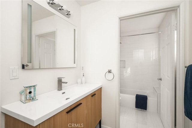 bathroom featuring vanity and tiled shower / bath