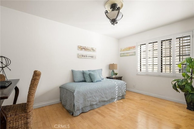 bedroom with hardwood / wood-style flooring