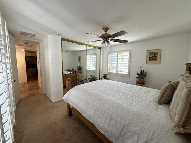 bedroom featuring ceiling fan, a closet, and carpet floors