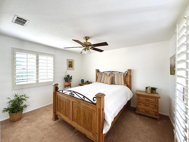 bedroom featuring ceiling fan and carpet