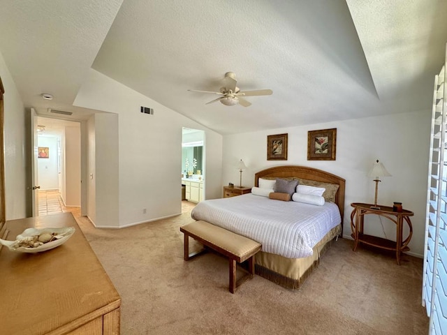 bedroom with connected bathroom, ceiling fan, light colored carpet, a textured ceiling, and vaulted ceiling