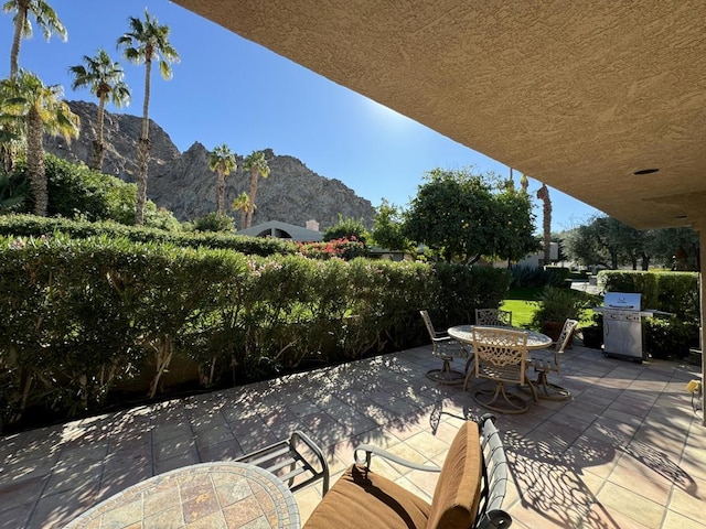 view of patio / terrace featuring a mountain view and area for grilling