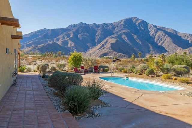 view of pool featuring a mountain view and a patio area