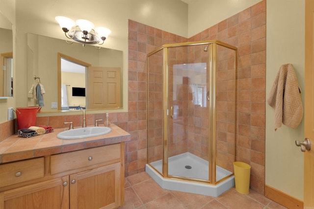 bathroom featuring vanity, tile patterned floors, and a shower with shower door