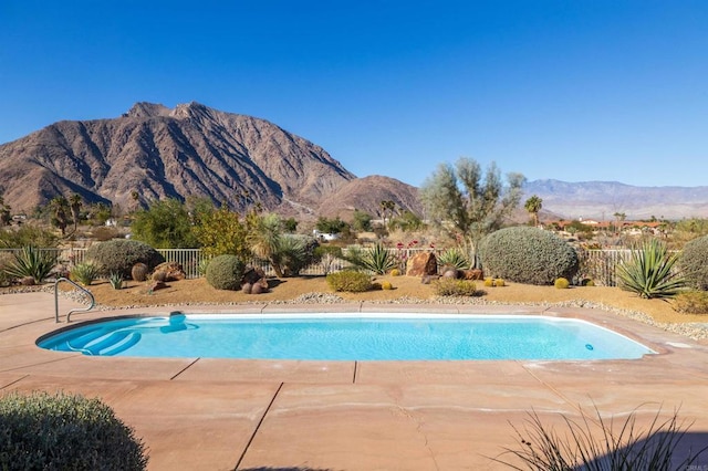 view of pool featuring a mountain view and a patio