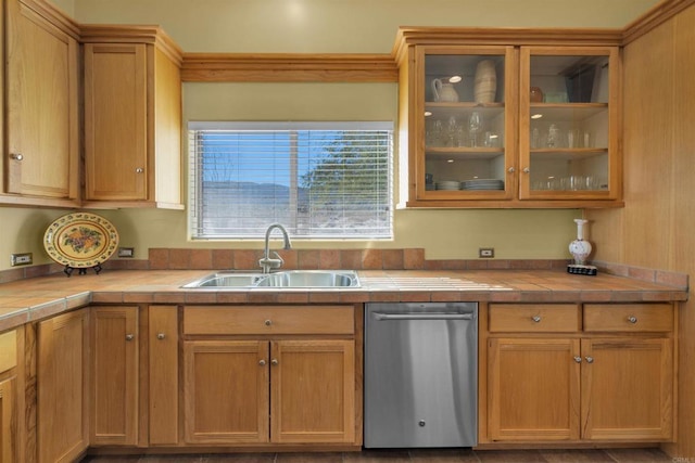 kitchen with tile countertops, stainless steel dishwasher, and sink