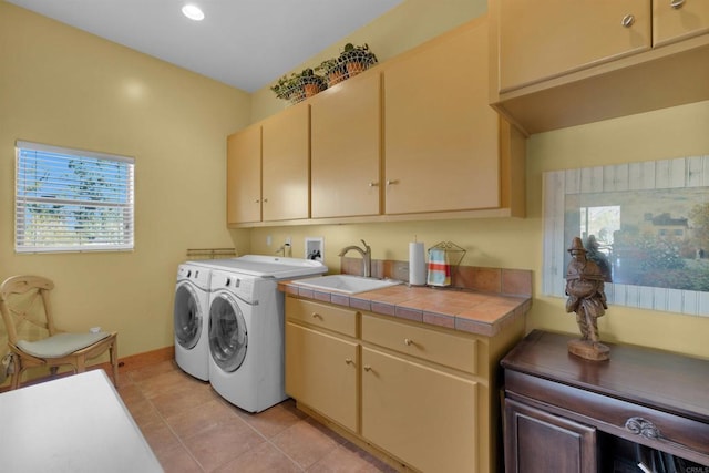 laundry area featuring cabinets, separate washer and dryer, light tile patterned flooring, and sink