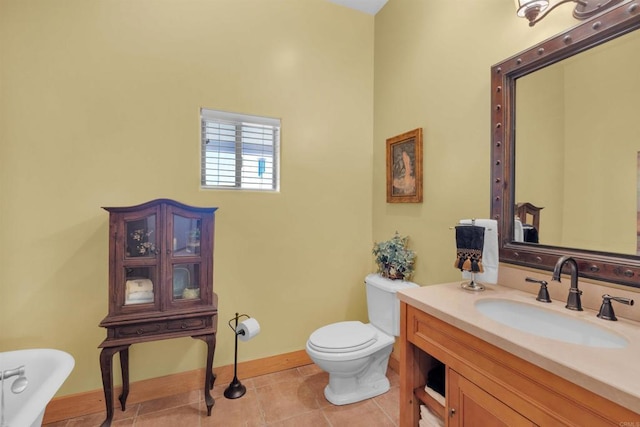 bathroom featuring tile patterned flooring, vanity, and toilet