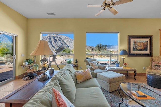 living room with tile patterned floors and ceiling fan